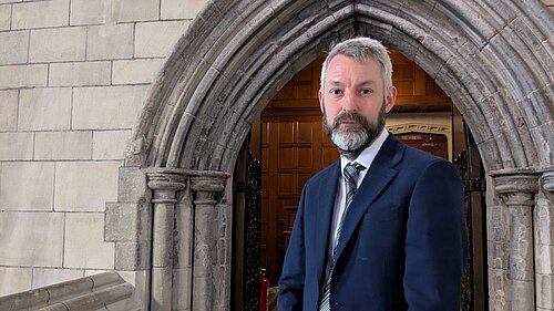 Will in front of door in Parliament