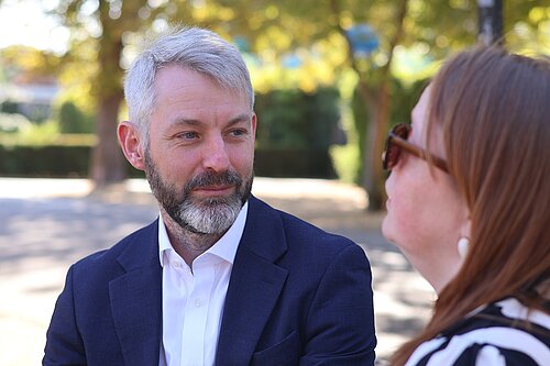 Will Forster speaking to constituent