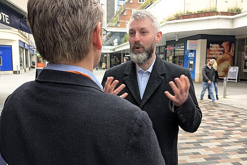 Will Forster talking to a constituent in Woking
